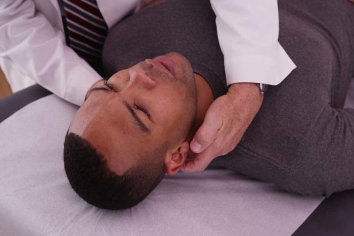Chiropractor adjusting patient's neck