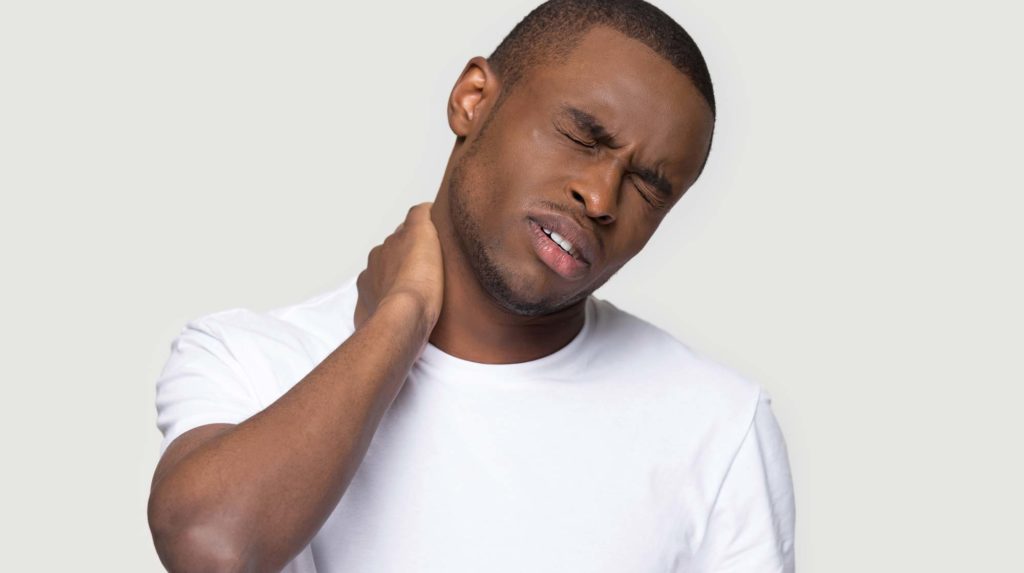 Man rubbing his neck in pain